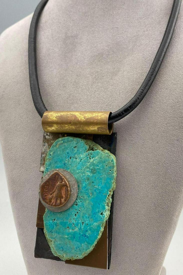 Shirley Wagner Pendant on Black Leather Chord: Shirley Wagner Pendant on Black Leather Chord Magnet Clasp Choker, signed Shirley Wagner, pendant 3.75 x 2.125 inches, chord length 20.25 inches, measurements are approximate. ALL CREDIT CARDS WILL BE