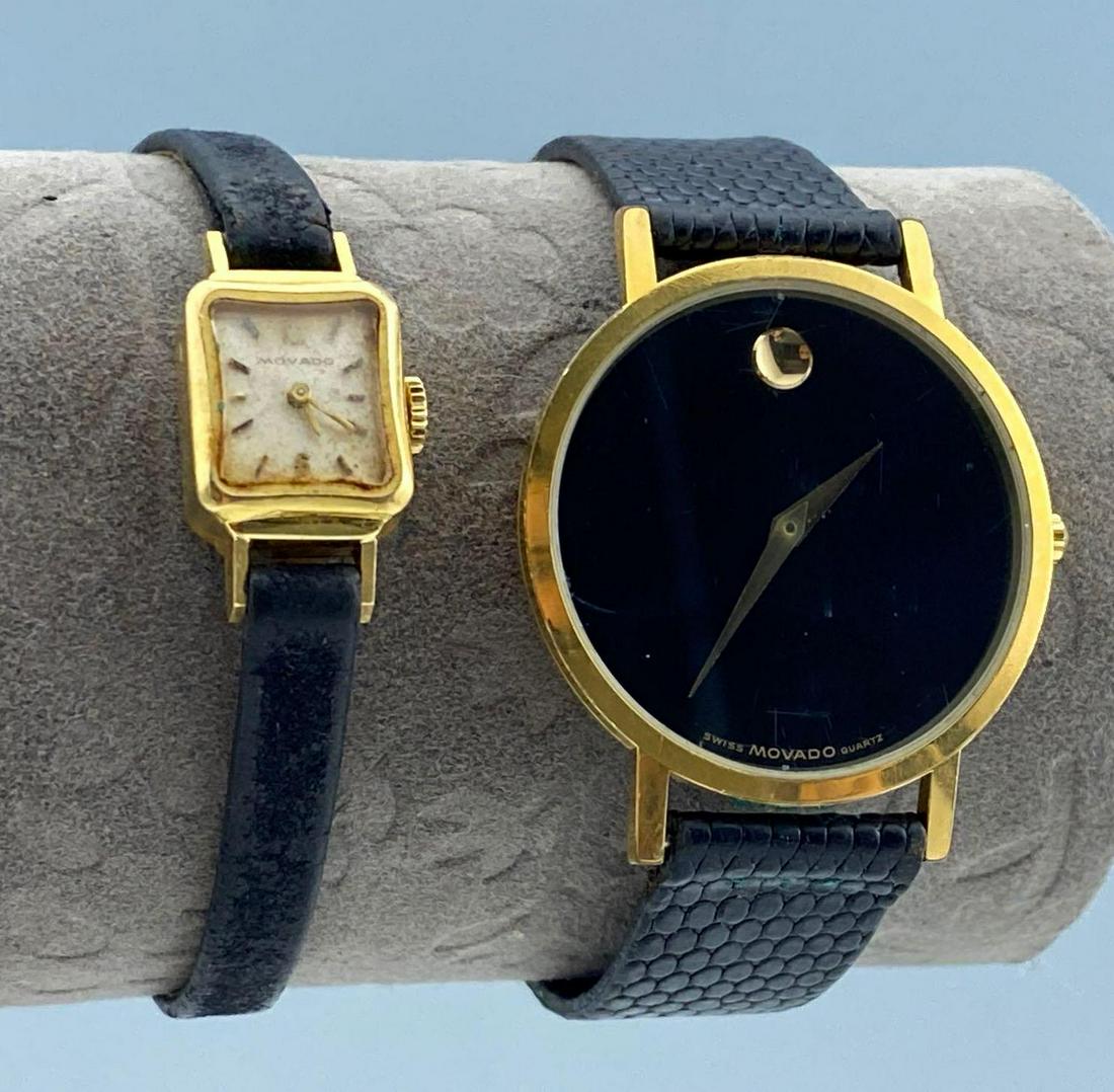2 Black & Gold Movado Watches: 2 Black & Gold Movado Watches, both marked Movado, both adjustable, larger watch piece 1.25 x 1.5 inches, thicker band width 0.5625 inches, full length 9.125 inches, smaller watch 0.5 x 0.875 inches,