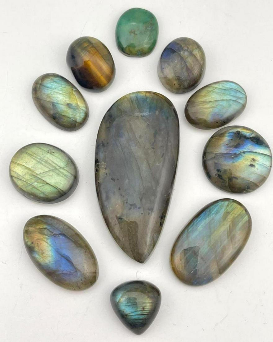 11 Labradorite and Semi Precious Stone Cabochons: 11 Labradorite and Semi Precious Stone Cabochons. Labradorite stones range from 1.875 in x .875 in x .25 in - .5 in x .5 in x .25 in. Measurements are approximate.