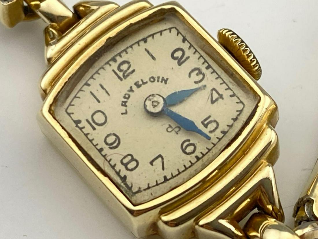 Lady Elgin 14k Gold Watch: Lady Eloin 14k Gold Watch with 10k Gold Filled Stretch Band, 13.1g, marked 14k & 10k GF, clock piece 0.625 x 1 inch, inner circumference 5.5 inches, measurements are approximate. ALL CREDIT CARDS WILL