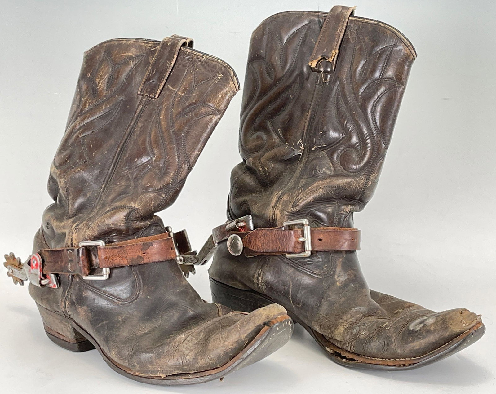 Favorite Boots And Spurs: Early 20th Century Men's Leather Cowboy Boots With Spurs. Boots have pull straps, quarter stitching, and D Toe. Spurs are swan neck with 8 shorter spikes. Inside marked 8736560 Shepler, 11 D. Appear
