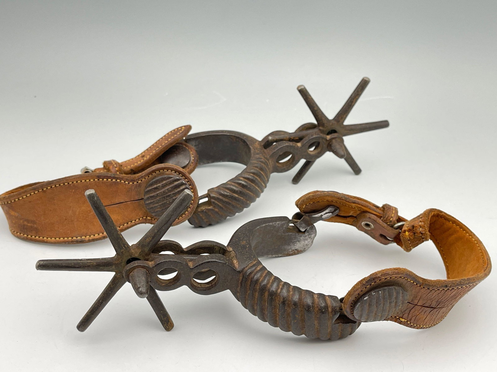 Vintage Mexican Leather Rowel 6 Tooth Boot Spurs: Vintage Mexican Leather Rowel 6 Tooth Boot Spurs. Tagged Hecho En Mexico.Yoke opening 3 in, shank 2.5 in, Rowels 4 in across. Measurements are approximate. From the private collection of the Estat