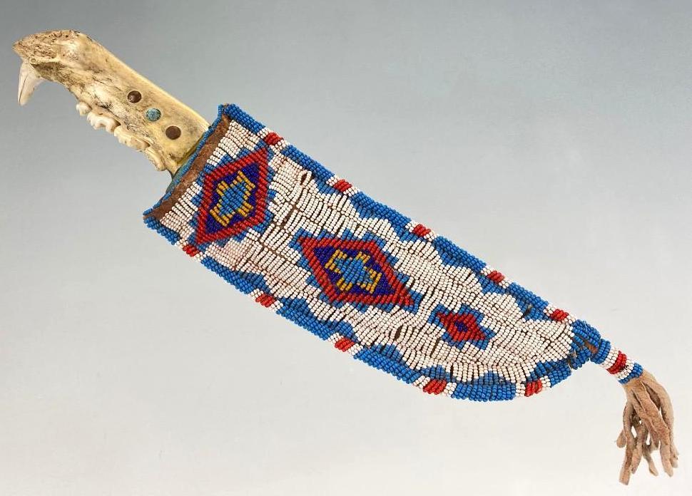 1900-1905 Sioux Sheath With Coyote Jaw Bone Knife: Native American Knife with Coyote Jaw Bone Handle and Sioux Leather Beaded Sheath. Approximately 9.75 x 1.75 x 0.625 in, sheath 11.125 x 3 x 1 in. 1900-1905 Red White Hearts,Sinew sewn. Knife may be 2
