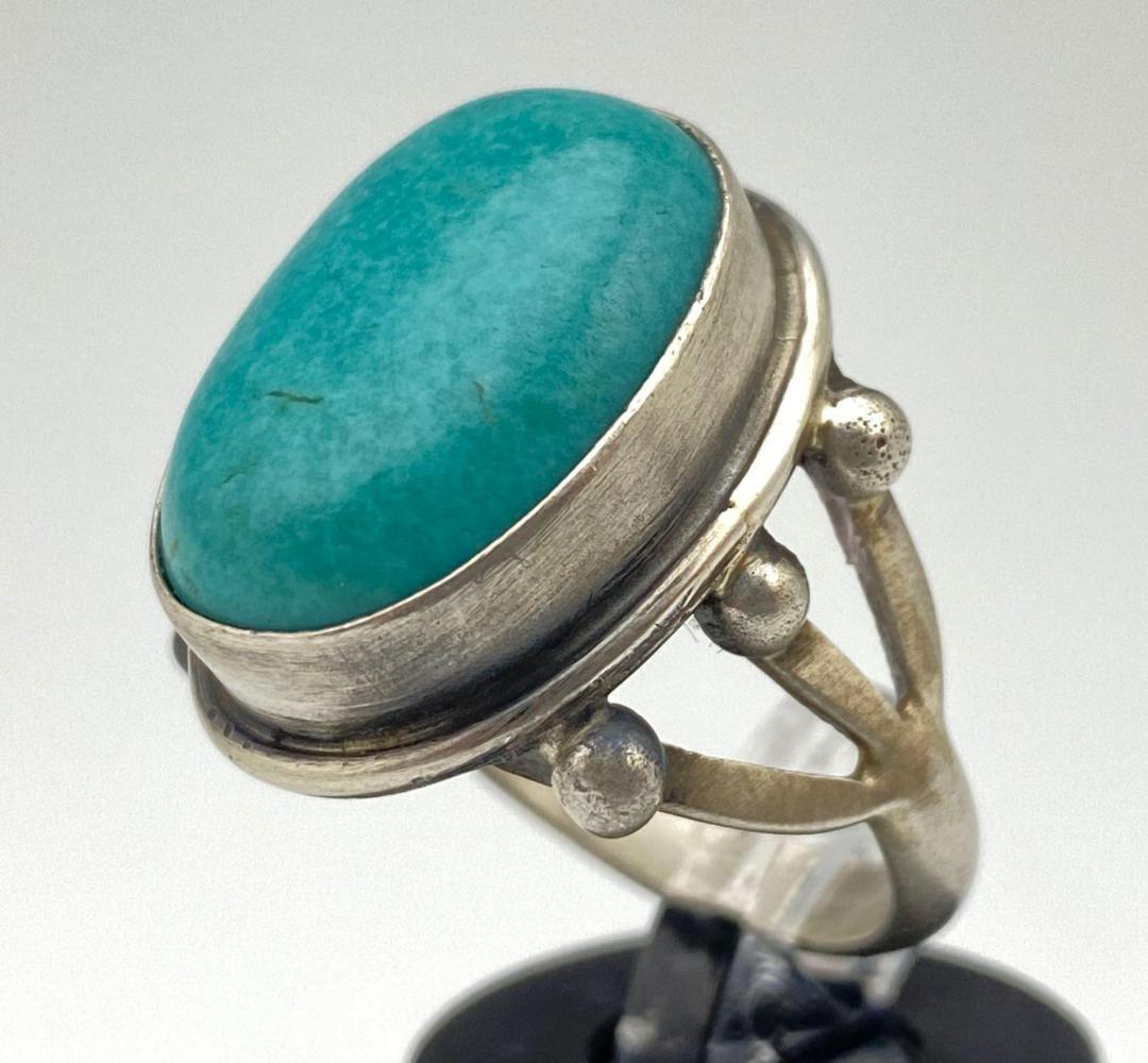 Navajo Sterling Silver and Turquoise Ring. 7.1 g: Navajo Sterling Silver and Turquoise Ring. 7.1 g, Signed AL, marked Sterling. Size 6, Gemstone Approximately .75 in. x .5 in.