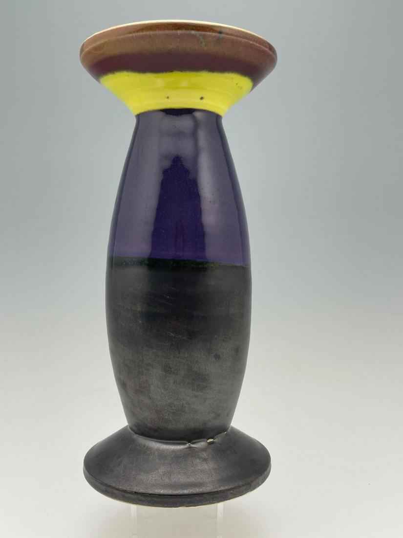 Peter Shire (Born 1947) Tall Expo Vase: Peter Shire (Born 1947) Tall Expo Vase in colors of purple yellow brown and gun metal black. Approximately 9.25 x 4.25 in.