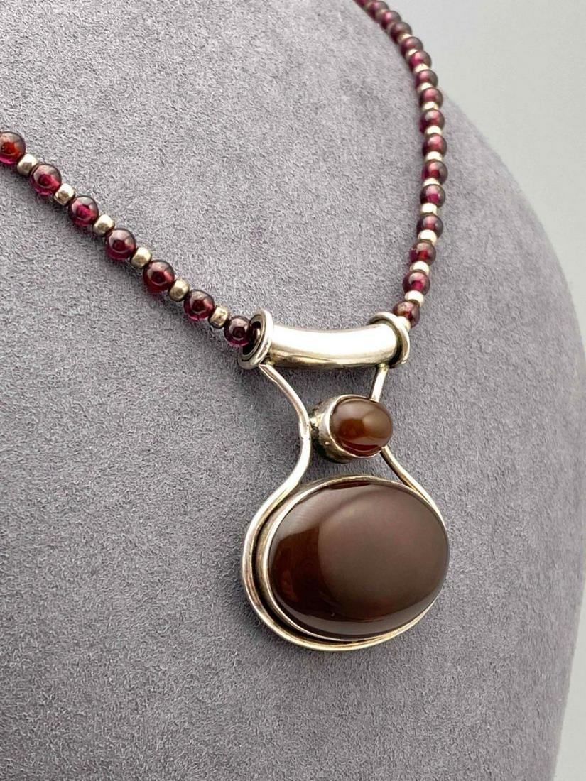 Amethyst Ball Bead Necklace With Carnelian Pendant: Amethyst Ball Bead Necklace With Carnelian Pendant. 30.3g. Pendant Marked 925. Necklace Approximately 18 in. long. Pendant Approximately 1.75 x 1.25 in.
