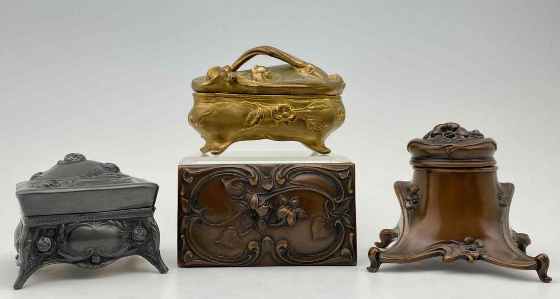 Lot of Art Nouveau Metalware: Two art nouveau metal jewelry or trinket boxes, an inkwell, and a blotter. Gold Color Container 4.25 x 3 x 2.5 in. Black Container 2.875 x 2.875 x 2.5 in. All measurements are approximate.