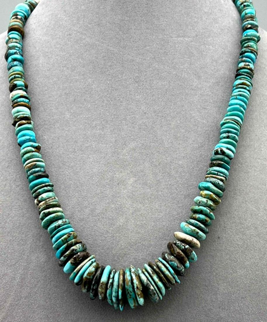 Navajo Turquoise Neclace With Graduated Turquoise Discs And Silver Cone Clasp: Navajo Turquoise Neclace With Graduated Turquoise Discs And Silver Cone Clasp. Unmarked, Silver Tested. 82.1g. Approximately 21.5L x 0.75W in.