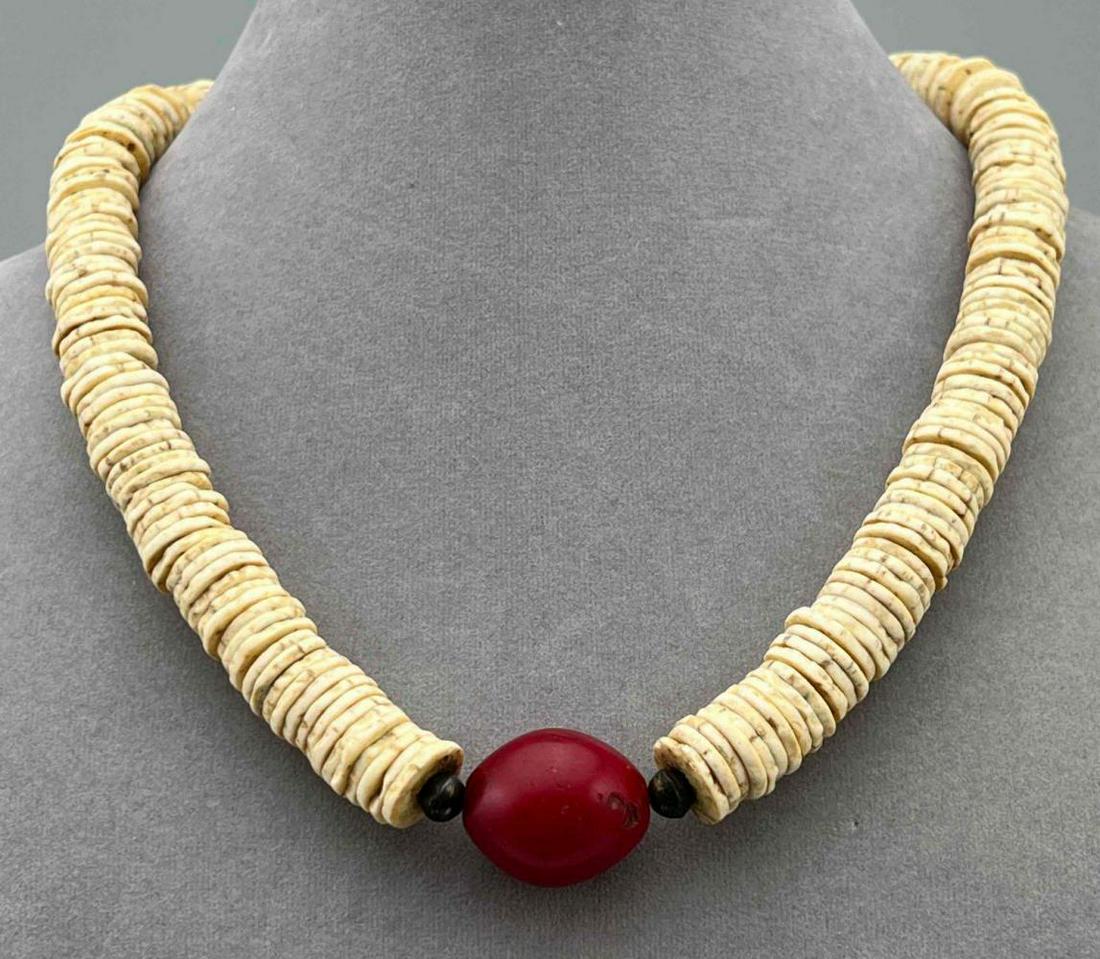 African Carnelian and Bone Beaded Necklace: African Bone Bead Necklace With Metal Hook Clasp. Approximately 19.0L x 0.75W in. Bone Beads 0.5 in Wide.