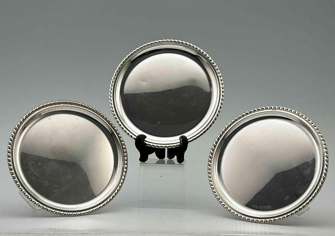 Three Italian 800 Silver Wine Or Champaign Bottle Coasters. 202.3g: Three Italian 800 Silver Wine Or Champaign Bottle Coasters. 202.3g. Marked 800. Tag Reads Gioielleria Nespoli S.R.I. Ferrara. Largest Approximately 5.375W in. Slammer Two Approximately 5.1875W in. ALL