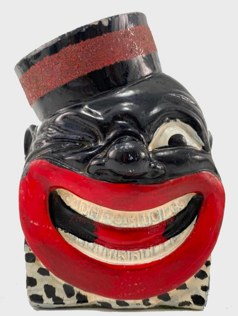 Black Americana Cigarette Holder "Coon Chicken Inn": Black Americana Cigarette Holder "Coon Chicken Inn", Marked Copyright ML Graham, Nationally Famous Coon Chicken Inn, Seattle, Salt lake, Spokane, Portland. Approximately 5.8125H x 4.4375W x 3.9375D in