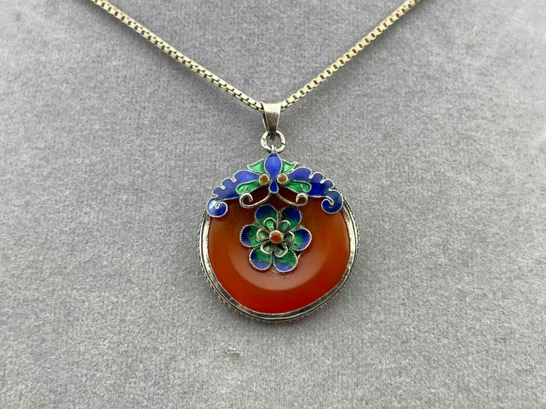 Sterling Silver And Carnelian Chinese Pendant With Cloisonne Butterfly Detail: Sterling Silver And Carnelian Chinese Pendant With Cloisonne Butterfly Detail On Sterling Chain. 8.9g. Chain Marked 925, Pendant Marked Silver. Pendant Approximately 1.0L x 1.0W in. Chain Approximatel