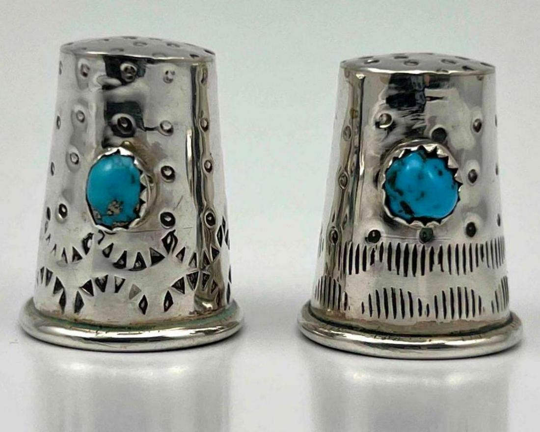 Two Navajo Sterling Silver And Turquoise Thimbles: Two Navajo Sterling Silver And Turquoise Thimbles Decorated With Hand Stamped Patterns. 9.3g. Marked Sterling. Approximately 1.0H x 0.75W in.