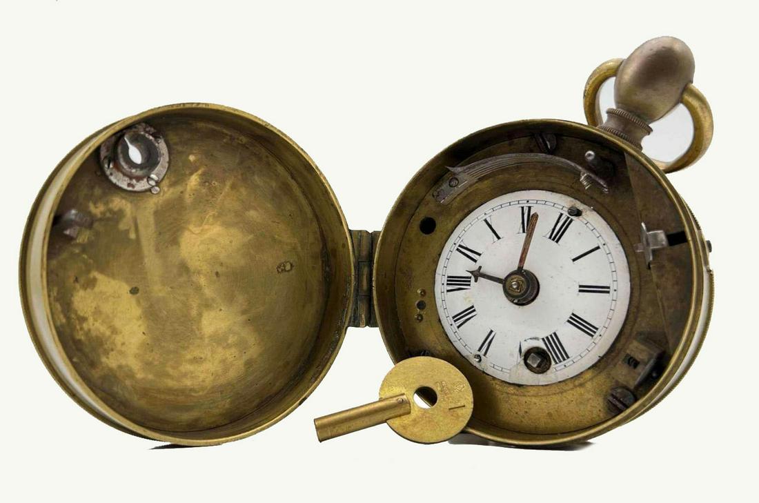 Antique Peter Burke Security Guard Watch With Key: Clock In Brass Case. Runs Inconsistently. Tag Reads Peter Burke CA 1846, Marked 26977. Key Marked P, Made In England. Approximately 4.0H x 3.0W in.