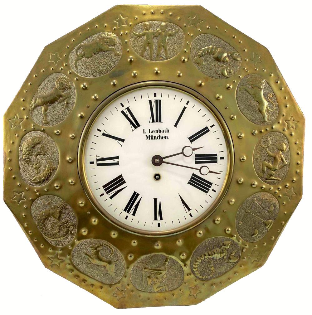 Ludwig Lenbach Wall Clock with Brass Zodiac Animal Relief, Circa 1920: Metal Clock With Reliefs Of Horoscope Images. Marked L Lenbach, Munchen. Approximately 19.3125W x 4.375D in.