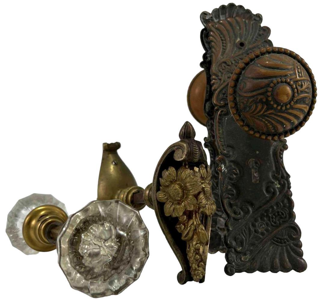 Lot of Three Antique Doorknobs: Three Antique Doorknobs, One With Decorative Lock Cover, One With Glass Handles. Largest Approximately 6.5L x 2.25W in. Smallest Approximately 6.5L x 2.0W in.