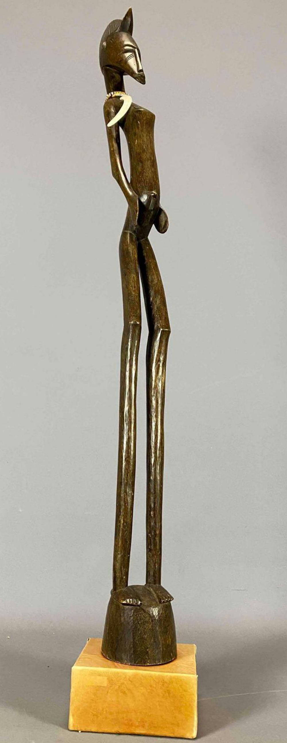 Senufo Tribe Ancestor Figure, Ivory Coast: Tall African Carved Wooden Statue With Claw Necklace. Tag Reads: Senufo Tribe Ancestor Figure, Ivory Coast, Picard 1980, CAXAX 1970. Approximately 48.3125H x 8.0625L x 7.5625W in.