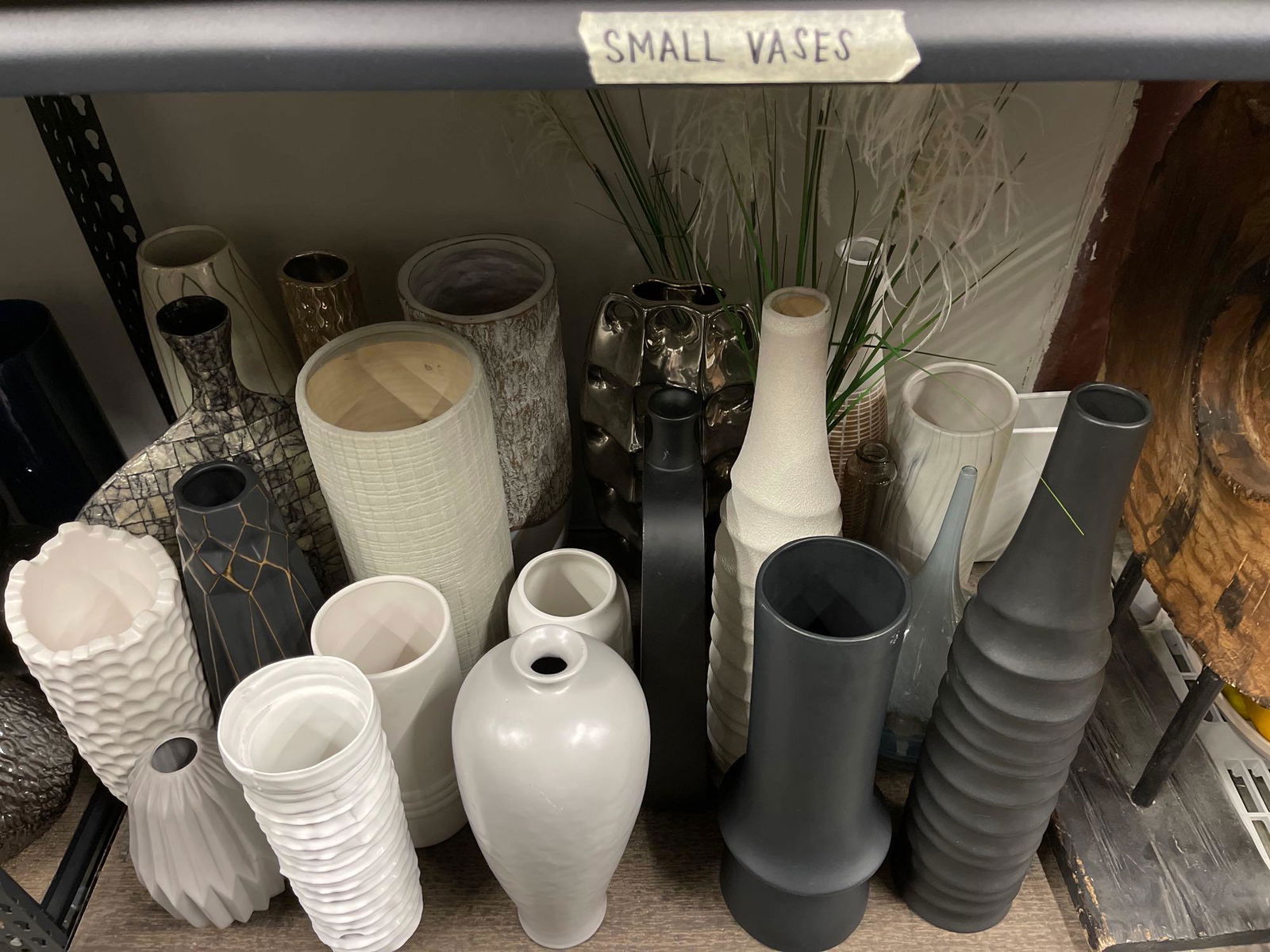 Bottom shelf of tall vases and decorative items (1 of 5)