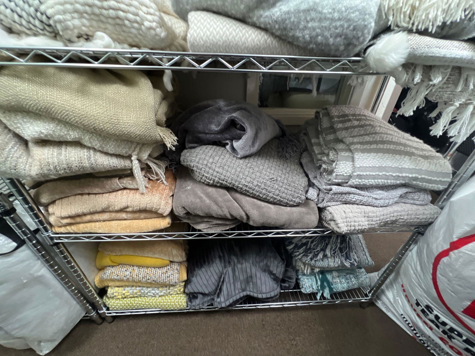 Shelf Of Grey & Beige Throw Blankets (1 of 1)