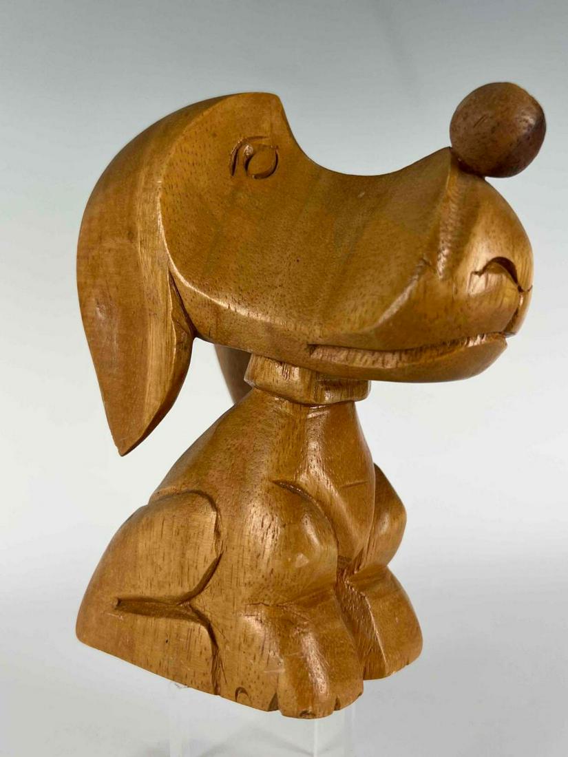 Folk Art Dog Carving, Circa 1950: Early 20th Century Folk Art Dog Carved Sculpture. Attractive Cartoon Form, Evocative of Early Snoopy and Droopy Designs. Approximately 6.25H x 5.5W x 2.5D in.