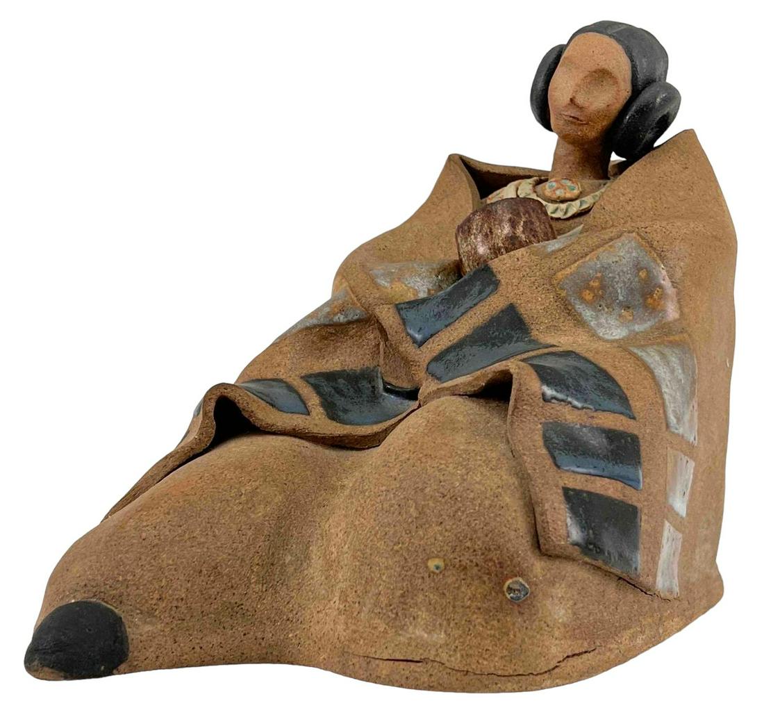 Native American Pottery Figure, Woman and Child, Signed: Ceramic Sculpture Of Sitting Woman Wrapped In Blanket. Signed Joan. Approximately 9.625H x 7.125W x 12.25L in.
