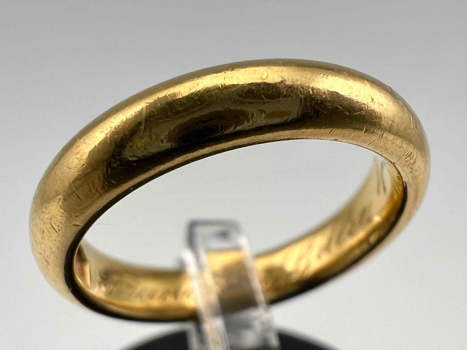 22K Gold Band: 22K Gold Band, 5.7g. Marked "Jaccards22kt." Width 0.125in. Ring Size 4.5.All measurements are approximate. ALL CREDIT CARDS WILL BE MANUALLY VERIFIED PRIOR TO SHIPMENT.