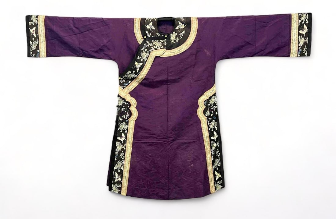 Fine Antique Chinese Purple Manchu Embroidered Robe: Chinese Purple Silk Manchu Robe. Embroidered butterfly and chrysanthemum details. Length 49.0 in. Sleeve Length 25.0 in. All Measurements are Approximate.