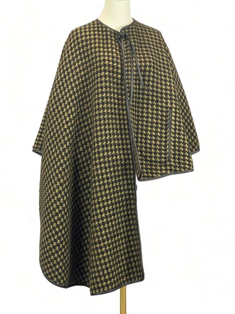 1960's Bonnie Cashin, Sills & Co. Asymmetrical Wool Capelet: 1960's Bonnie Cashin Sills & Co. Asymmetrical Wool Capelet.Tags marked "Bonnie Cashin Design Sills & Co." and "Saks Fifth Avenue." Length at front 41.0 in. Length at back 23.0 in. Al