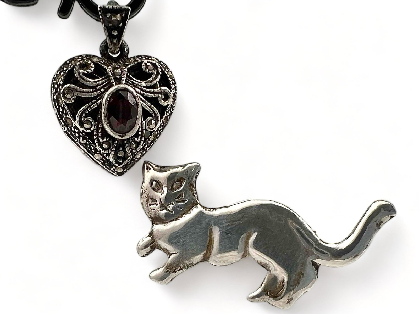 Sterling Silver Garnet Locket & Cat Pin: Sterling Silver Garnet Locket & Cat Pin. Marked 925. Locket approximately 0.75L x 0.75W in. Cat Pin approximately 1.375L x 0.5H in.
