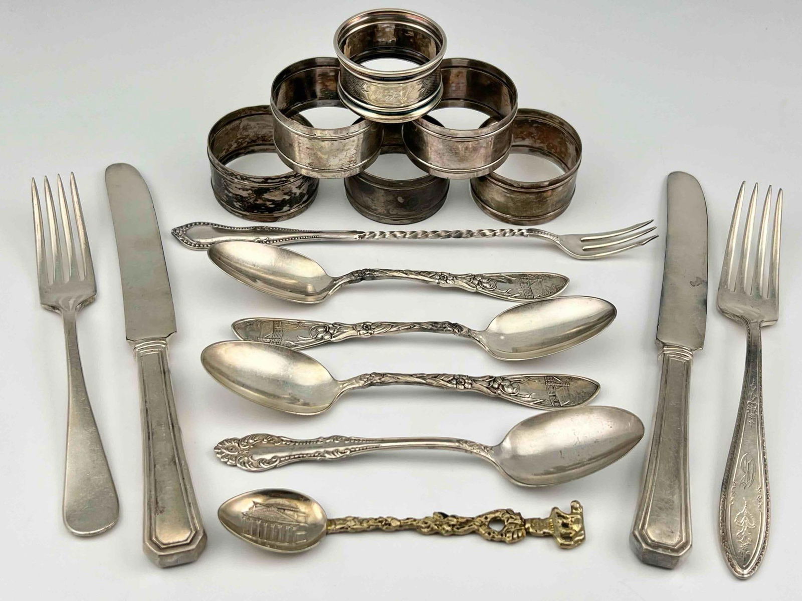 Antique Silverplate Flatware & Napkin Rings: Antique Silverplate Flatware & Napkin Rings. Largest piece 8.625L x 0.75W in. Smallest piece 4.75L x 1.0W in.