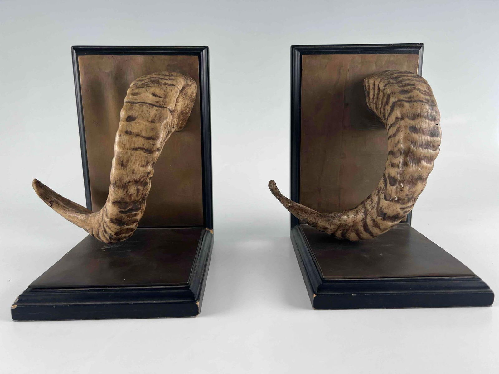 Pair Of Faux Horn Hunting Trophy Bookends: Pair Of Faux Horn Hunting Trophy Bookends. Please note that one bookend is loose at joinery. Approximately 8.125H x 6.25L x 6.25W in.