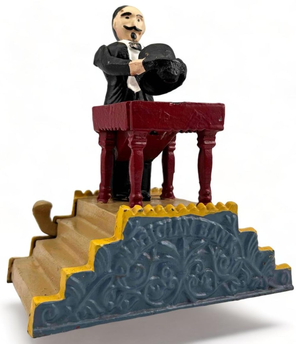 Cast Iron Magician Mechanical Toy Bank: Cast Iron Magician Mechanical Toy Bank. Marked "Magician Bank." Approximately 8.0H x 7.0W x 4.0D in.