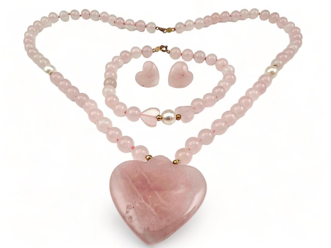 14K Rose Quartz Heart Form Jewelry Suite: 14K Rose Quartz Heart Form Jewelry Suite. 40.9g. Clasp marked "14K Hong Kong." Includes Necklace, Earrings and Bracelet. Smallest (Earrings) 0.125W x0.125L in, Largest (Necklace) 9.625L x 1.25W in. Al