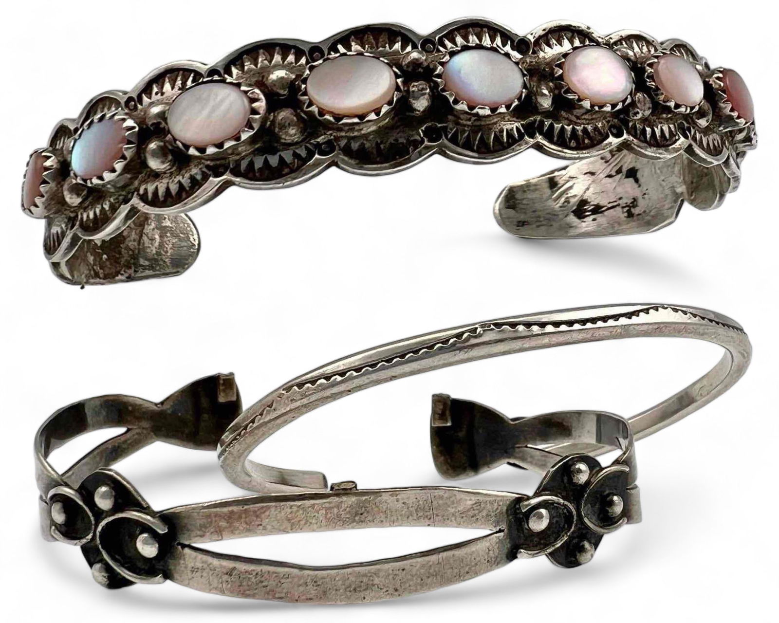 Three Native American Sterling Silver Cuff Bracelets: Three Native American Sterling Silver Cuff Bracelets. 46.7g. Largest Signed "LM.Y." Marked "Sterling." Inner cuff 3.0 in. Cuff break 1.5 in. Width approximately 0.5in. Second inner cuff 2.5 in. Cuff b