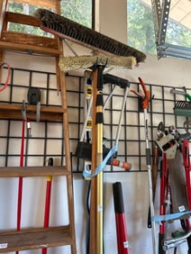 Two Push Brooms, Level, And Sprinkler