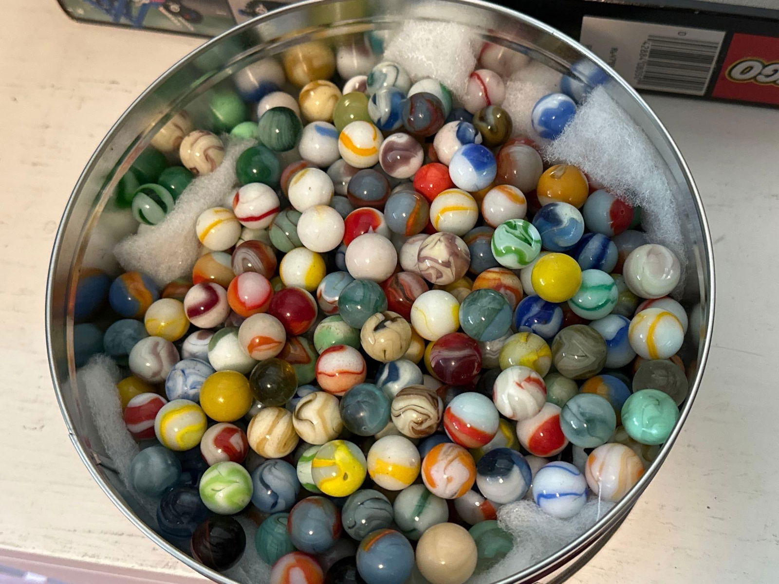 Tin Of Older Marbles: Tin Of Older Marbles. SHIPPING AVAILABLE FOR THIS LOT THROUGH LISTED SHIPPERS. Pick-Up will be Thursday Aug 8th & Saturday Aug 10th from 11:00-4:00. Shipped items must have shipping arranged by Saturd