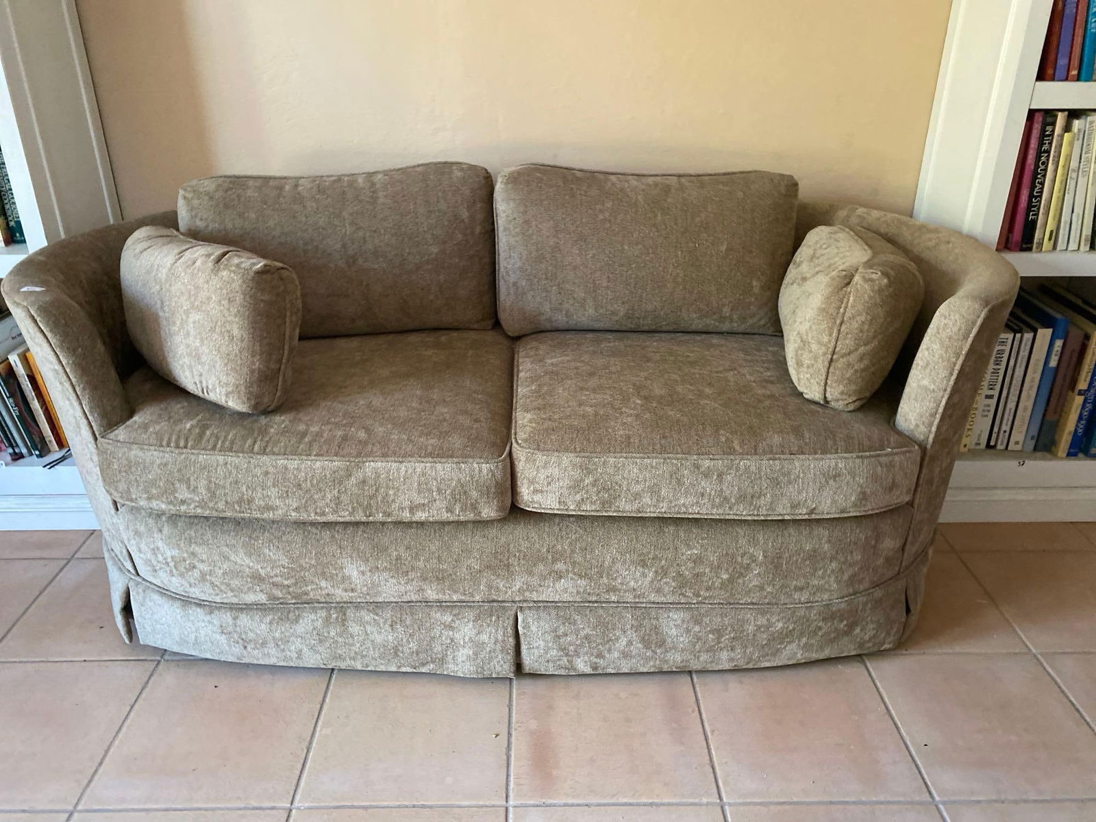 Curved Taupe Loveseat: Curved taupe loveseat. Upholstery in very good condition. Approximately 67L x 30D x 26H in. NO SHIPPING AVAILABLE FOR THIS LOT, LOCAL PICK UP ONLY