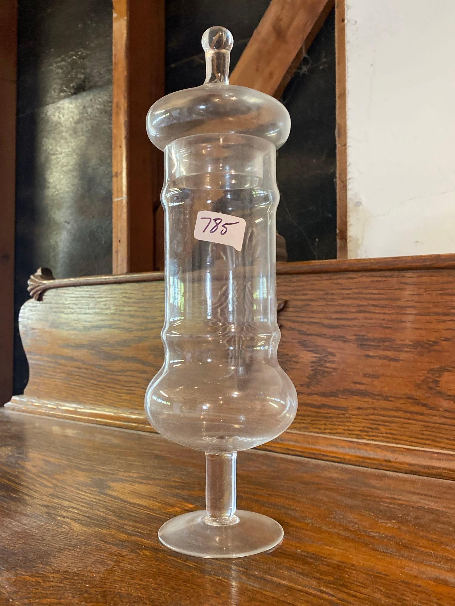 Glass Apothecary Jar: Glass apothecary jar. Approximately 13.75 high X4.0 W inches. Shipping available for this lot.