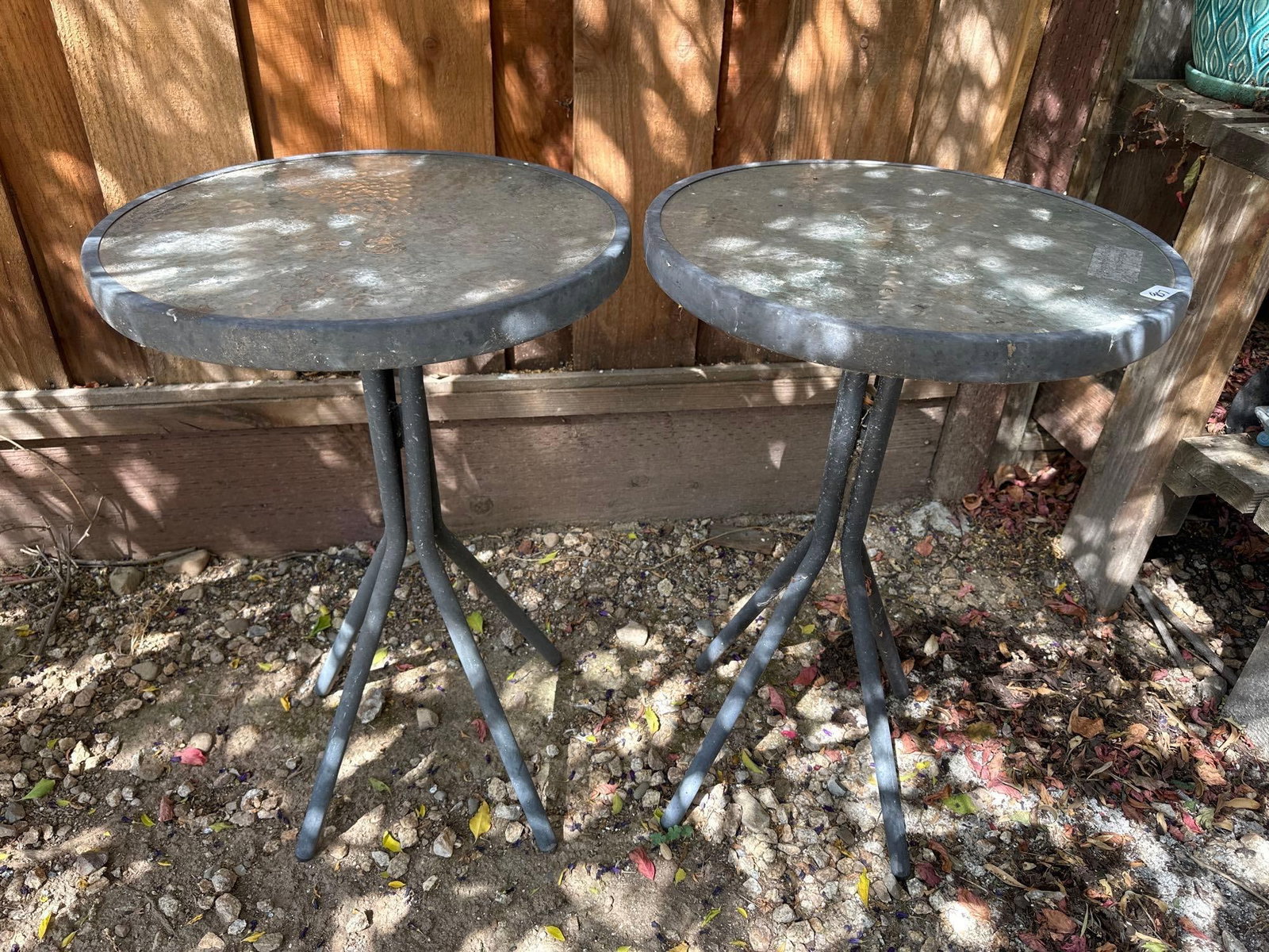 Pair Of Tempered Glass Outdoor Side Tables: Pair of tempered glass outdoor side tables. Each approximately 27.75H x 18.0W x 18.0D in. NO SHIPPING AVAILABLE FOR THIS LOT, LOCAL PICK UP ONLY
