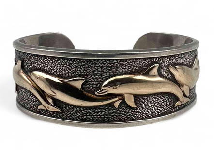 Sterling Silver, 14K Dolphin Cuff Bracelet: Sterling Silver, 14K Dolphin Cuff Bracelet, 55.3g. Marked "Kabana Sterling 14K." Inner cuff 5.25in. Cuff break 0.875in. Width 0.75in. All measurements are approximate.