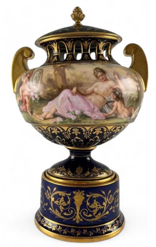 Royal Vienna Hand Painted Porcelain Potpourri Urn: Royal Vienna Hand Painted Porcelain Potpourri Urn. Marked "699." Please note that piece is somewhat loose in connection to base at bolt. Approximately 12.75H x 7.5W x 5.5D in.