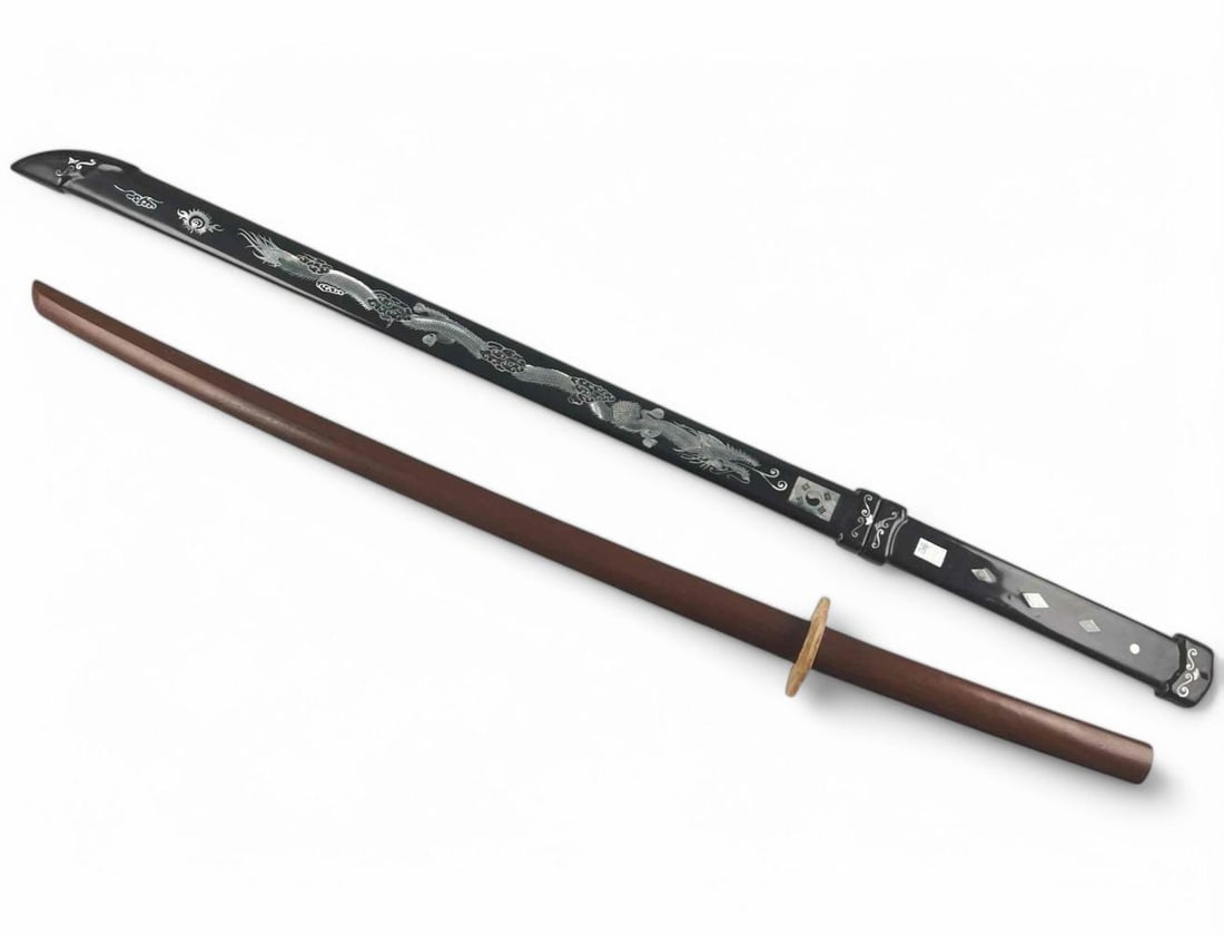 20th C. Bokken & Mother of Pearl Inlay Korean Sword: 20th C. Bokken & Mother of Pearl Inlay Korean Sword. Sword is not removable from sheath. Bokken approximately 38.75L x 1.5W x 0.75D in. Sword approximately 43.0L x 2.125W x 0.875D in.