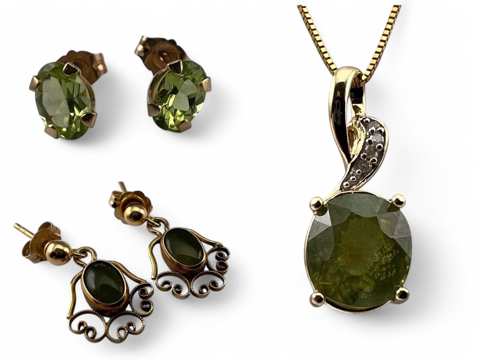 10K Peridot Necklace & Earrings: 10K Peridot Necklace & Earrings, 4.0g. Marked or test as 10K. One earring back 14K. Pendant approximately 0.75L x 0.25W in. Stone 8.0 x 7.0 mm. Chain length 20.0in. Earrings approximately 6.0 x 3.9 mm