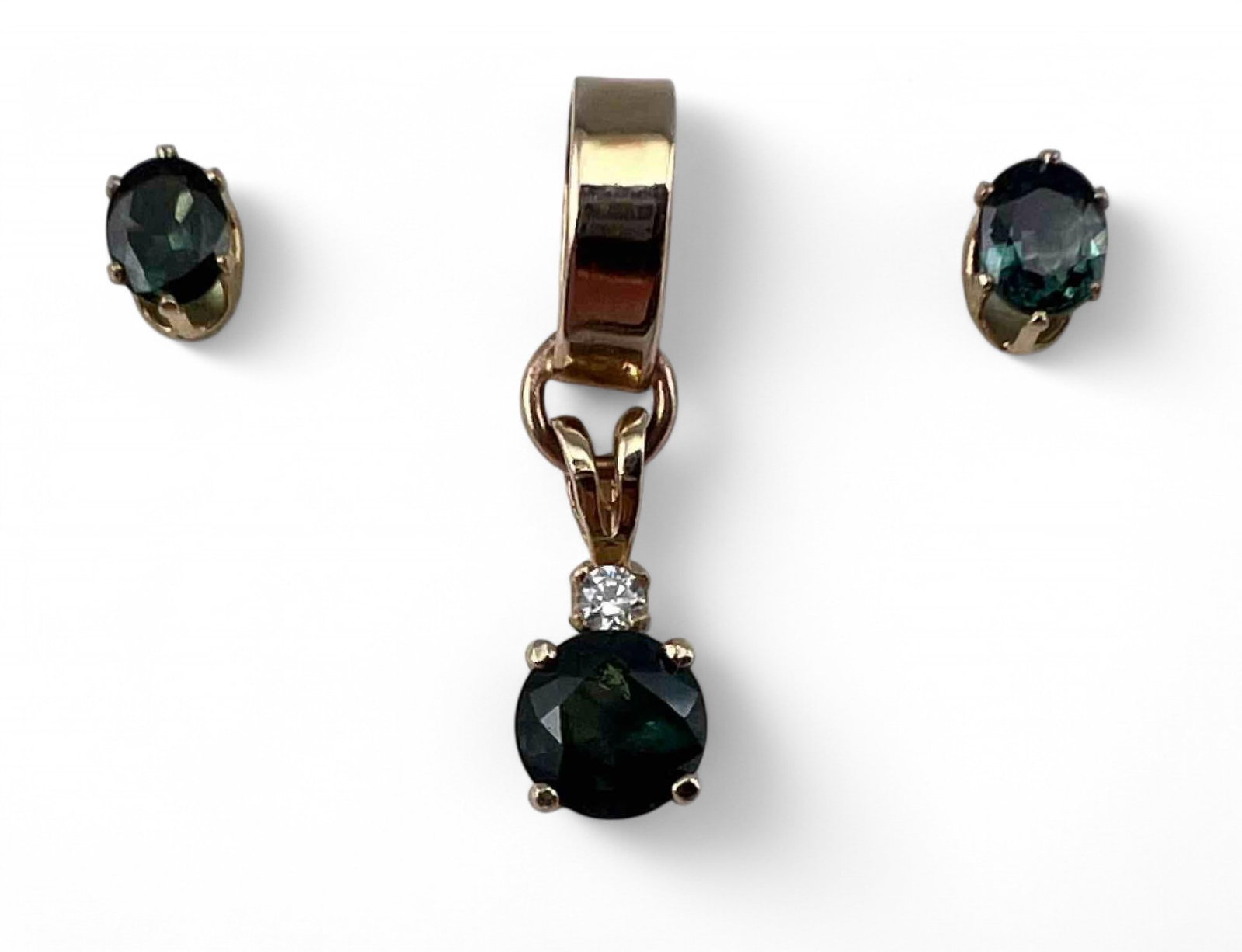 14K Blue Sapphire Pendant: 14K Blue Sapphire Pendant & Earrings, 2.1g. Pendant marked 14K. Earrings marked 14K. Pendant approximately 0.95L x 0.25W in. Sapphire approximately 6.0mm. Earrings approximately 5.0 x 4.0 mm.PLEASE NO