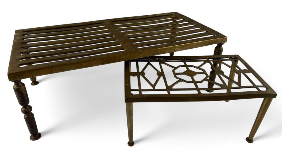 Two 19th Century Brass Trivets: Two 19th Century Brass Trivets. Underside of larger marked "1800 18 x 9." Smaller marked "220." Larger approximately 18.0L x 9.0W x 6.0H in. Smaller approximately 10.25L x 6.0W x 4.875H in.