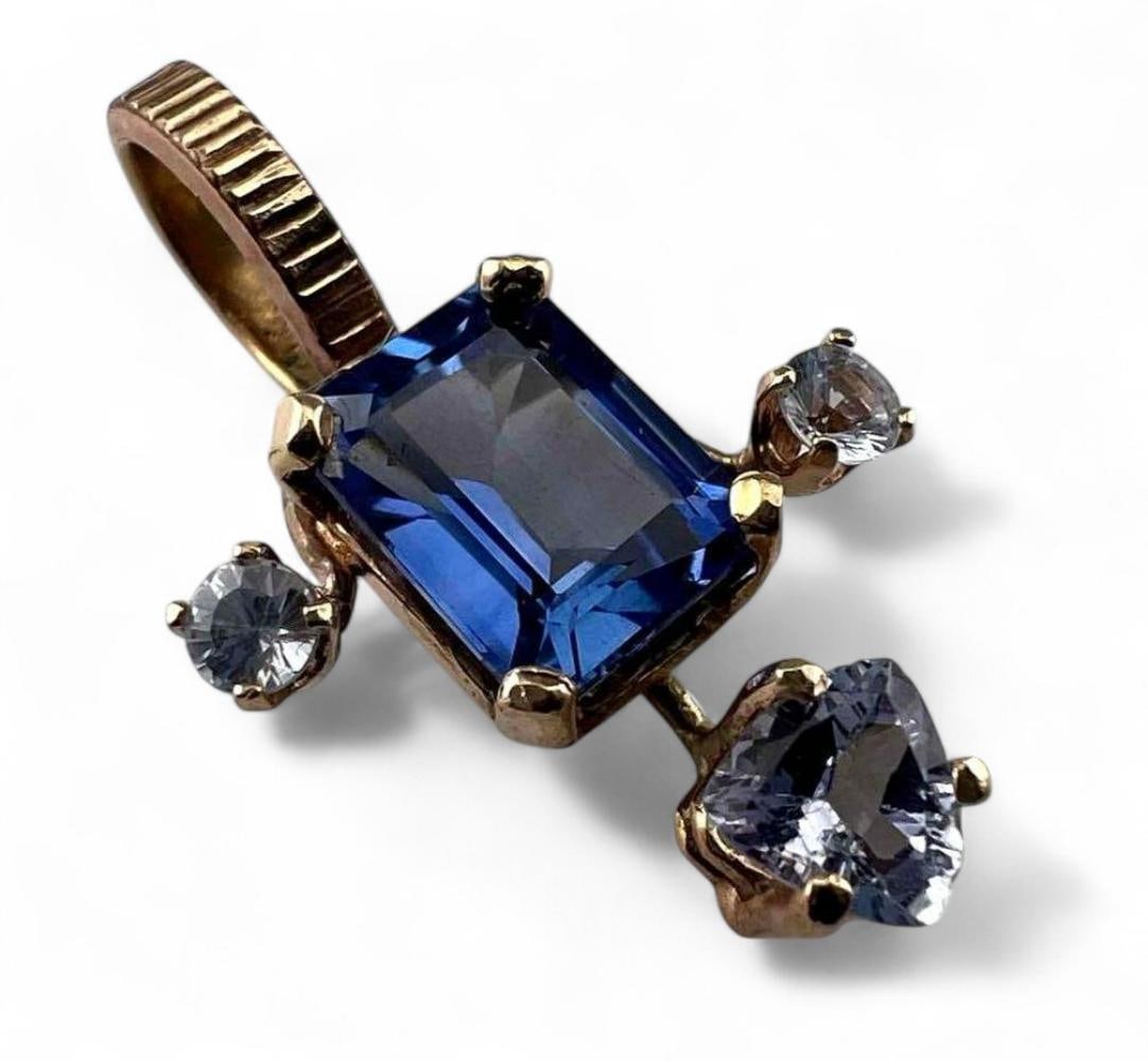 14K, 10K Blue Sapphire Pendant: 14K, 10K Blue Sapphire Pendant, 2.5g. Unmarked, pendant tests as 14K, bale portion tests as 10K. Blue sapphire accented with two white sapphires (smaller white stones) and CZ (center triangular white 