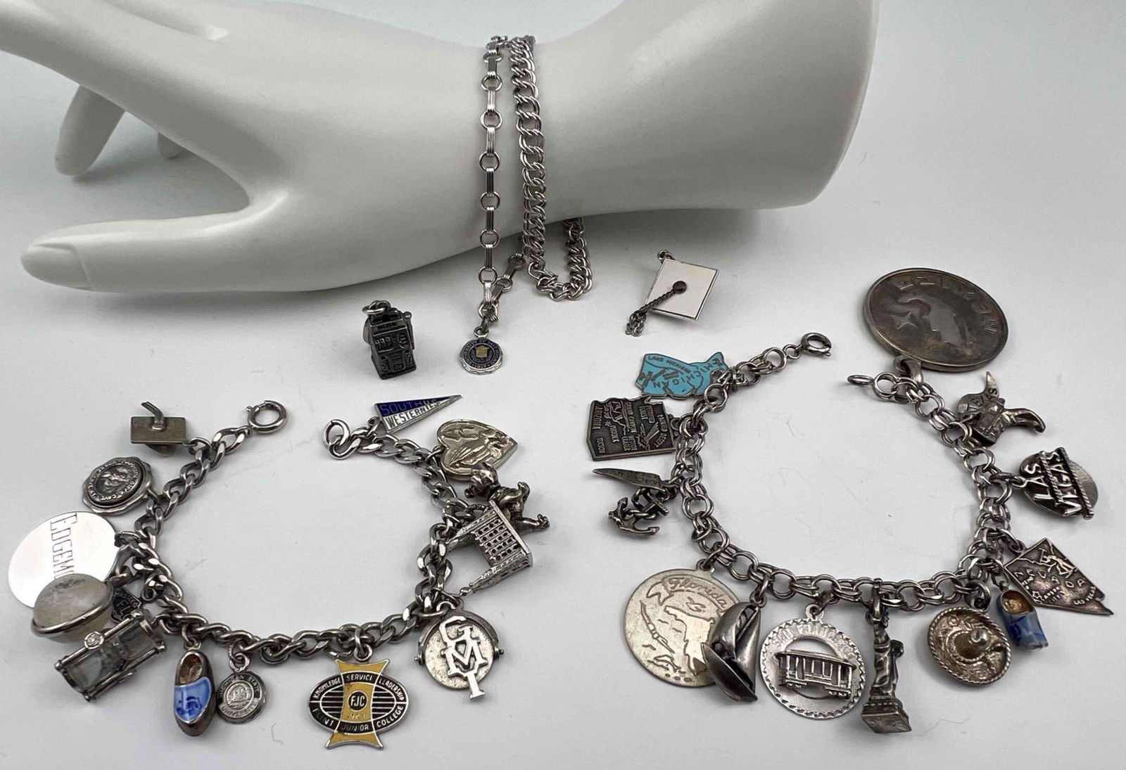 Sterling Silver Charms & Charm Bracelets: Sterling Silver Charms & Charm Bracelets, 106.8g. Bracelets and charms marked or test as sterling. Includes four bracelets and thirty charms. Largest charm approximately 1.30in. Smallest charm approxi