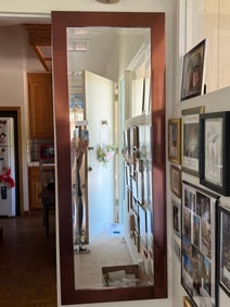 Full Length Beveled Mirror With Copper Colored Trim.