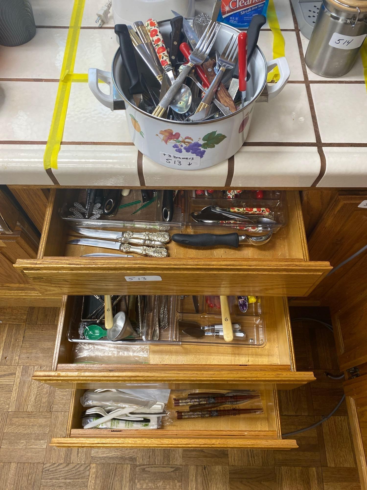 Pot Filled With Utensils And Three Drawers Of Flatware.: Pot filled with utensils and three drawers of utensils.