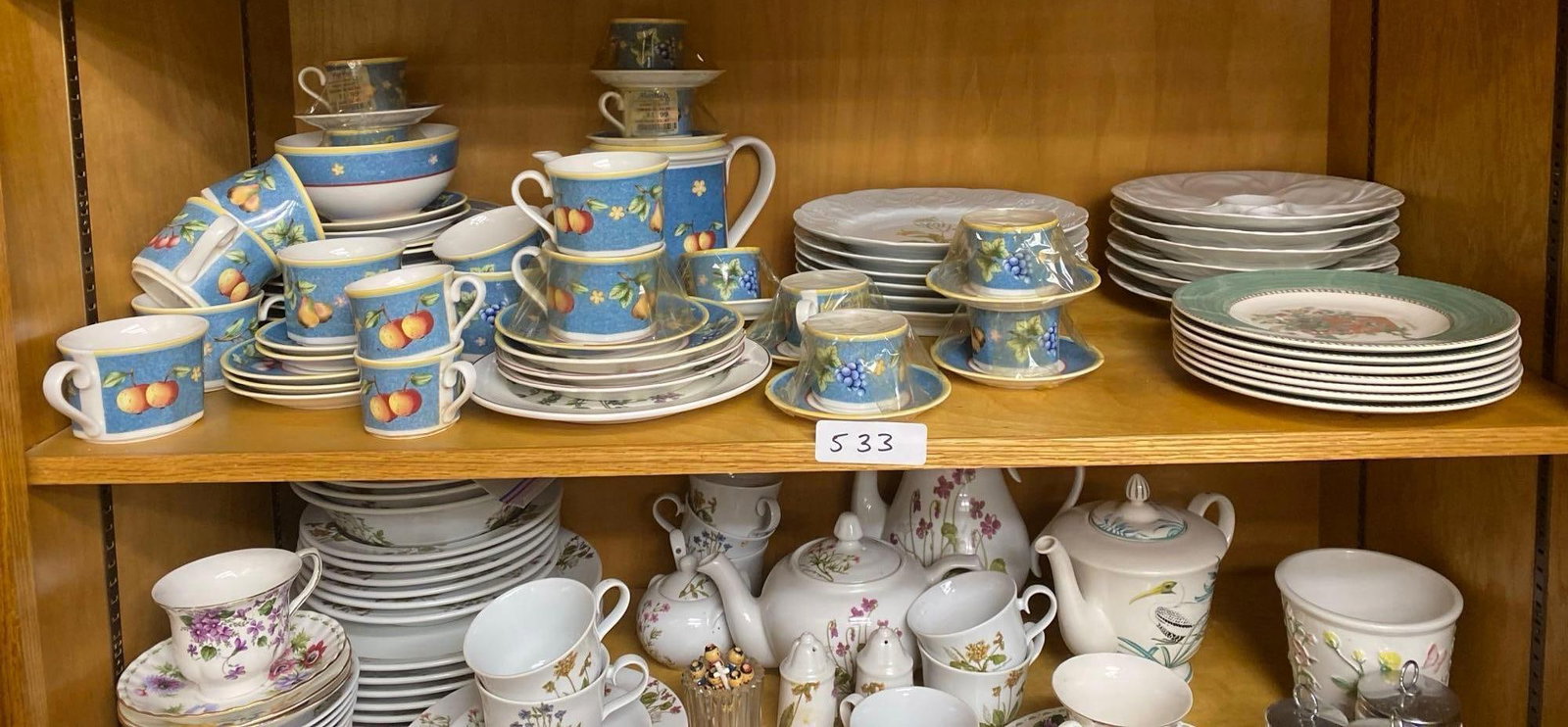 Pillevuyt Oyster Plates, Wedgwood "Sarah'S Garden" Pattern & Dansk Botanical Pattern Luncheon Plates: Shelf of Dishes, including Pillevuyt oyster plates, Wedgwood "Sarah's Garden" pattern, Villeroy & Boch, & Dansk botanical pattern luncheon plates.